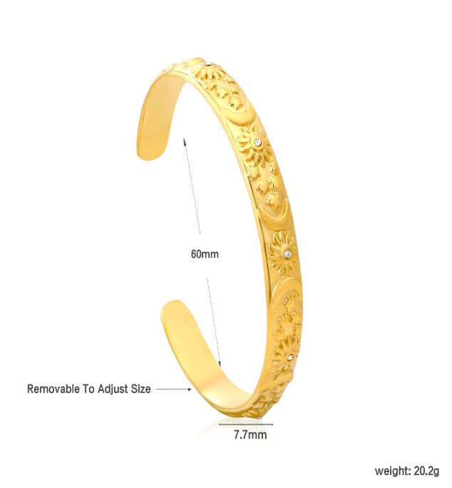 Gold celestial bracelet with engraved design on a white background
