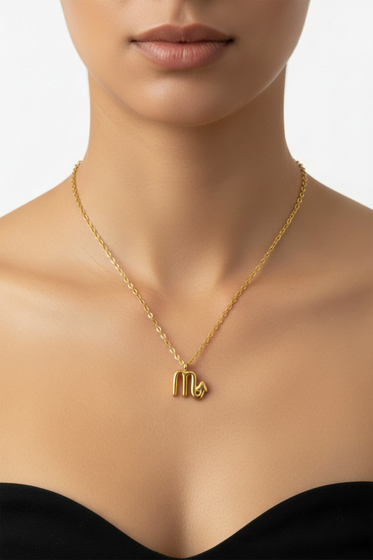 womans neckline wearing Gold necklace with a zodiac symbol pendant on a white background