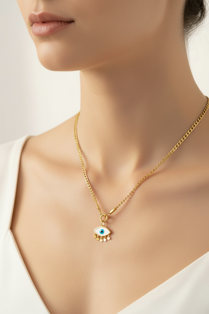 womans neckline wearing the All Seeing Eye Mini Clasp Gold-plated necklace with an eye-shaped pendant, wearing a white v neck tshirt, on a white background