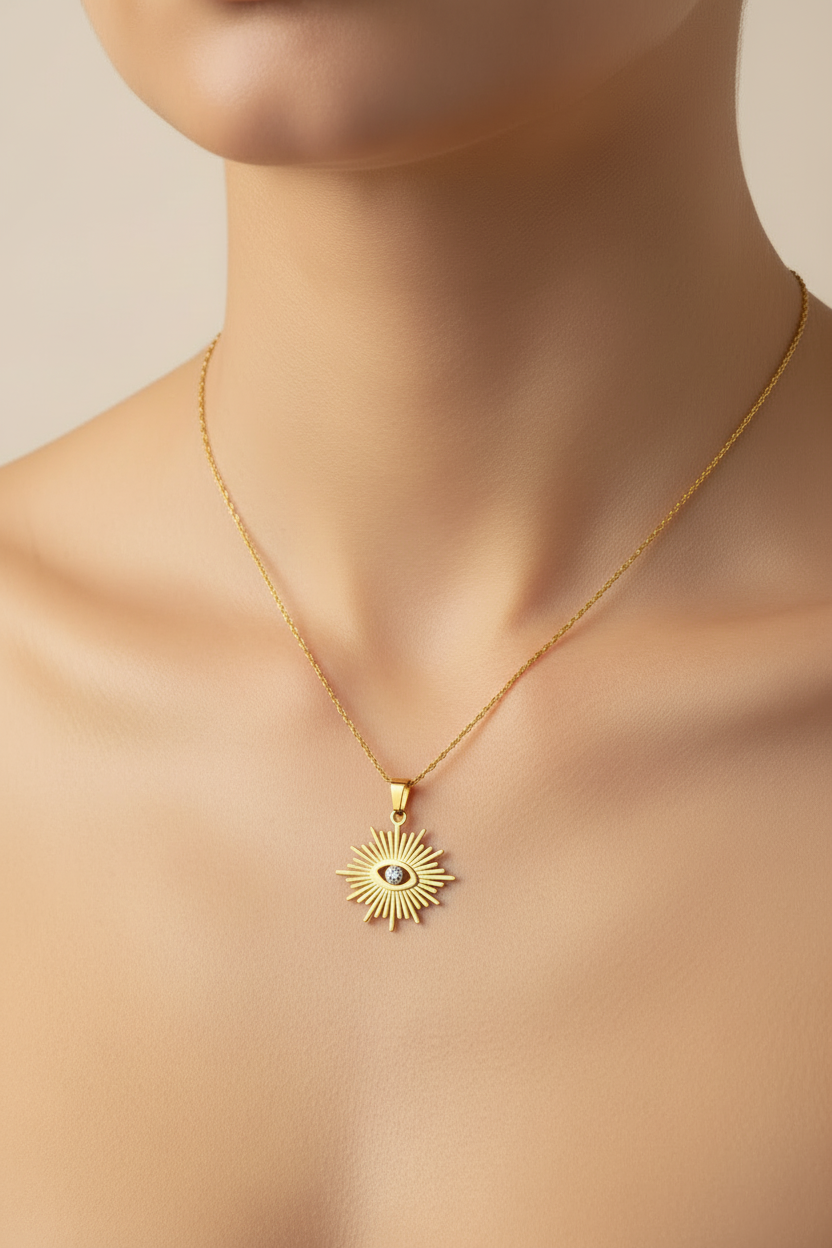 womans neckline wearing a Gold necklace with a sun-shaped pendant featuring an eye design on a white background