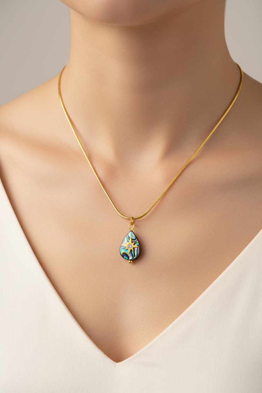 womans neckline with white v neck tshirt and mother of pearl star teardrop necklace